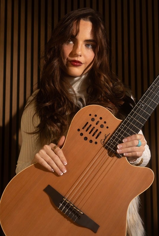 Chloe holding her guitar